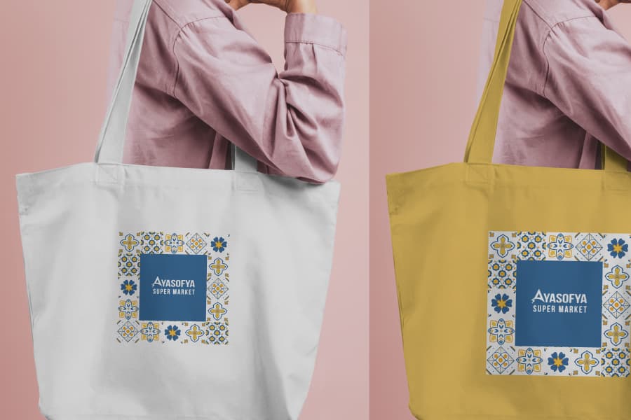 Two Ayasofya tote bags, one natural and one yellow, carried over a shoulder