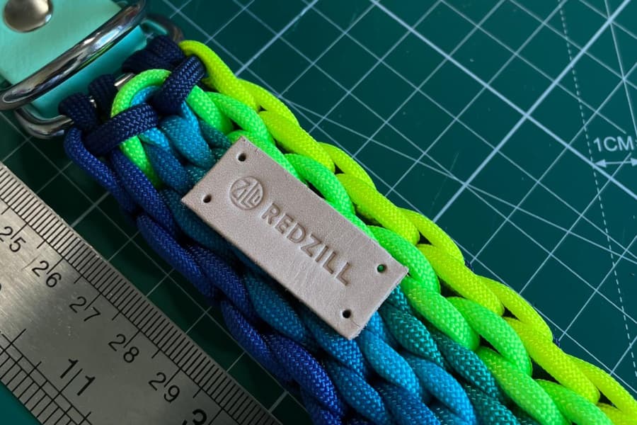 Redzill collar and its stamped metal label on a cutting mat